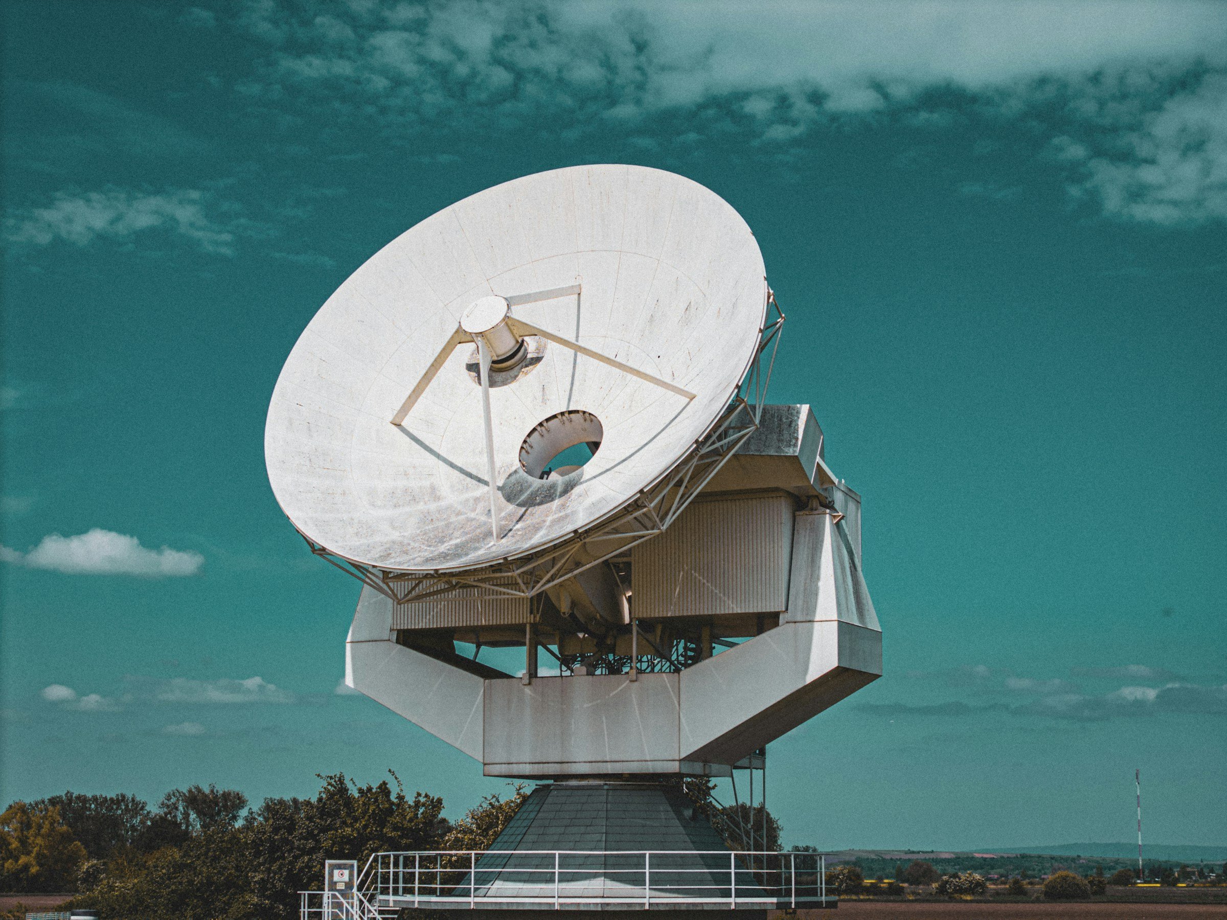 Large satellite dish ground station against a blue sky